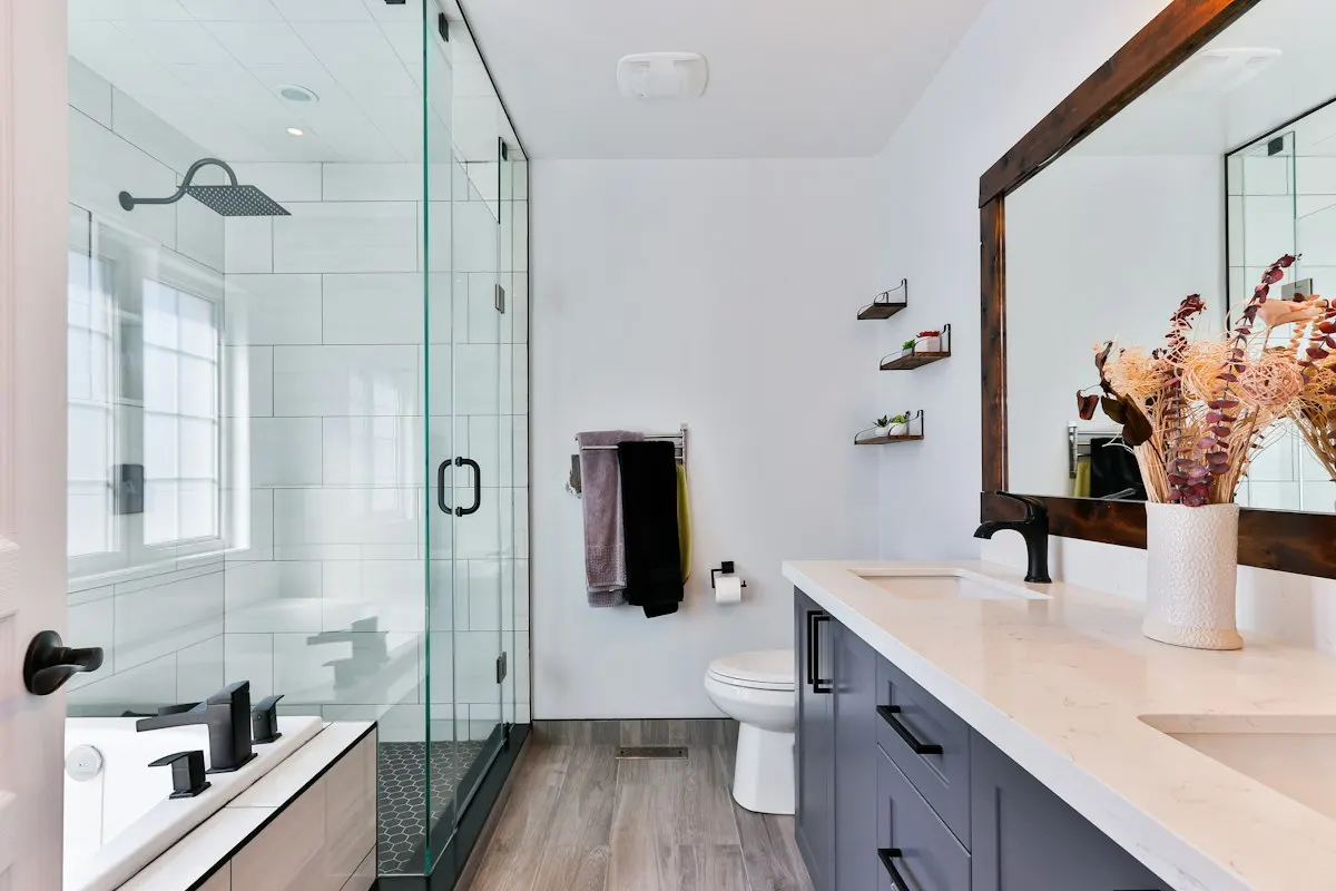 Bathroom vanity facing a glass shower enclosure