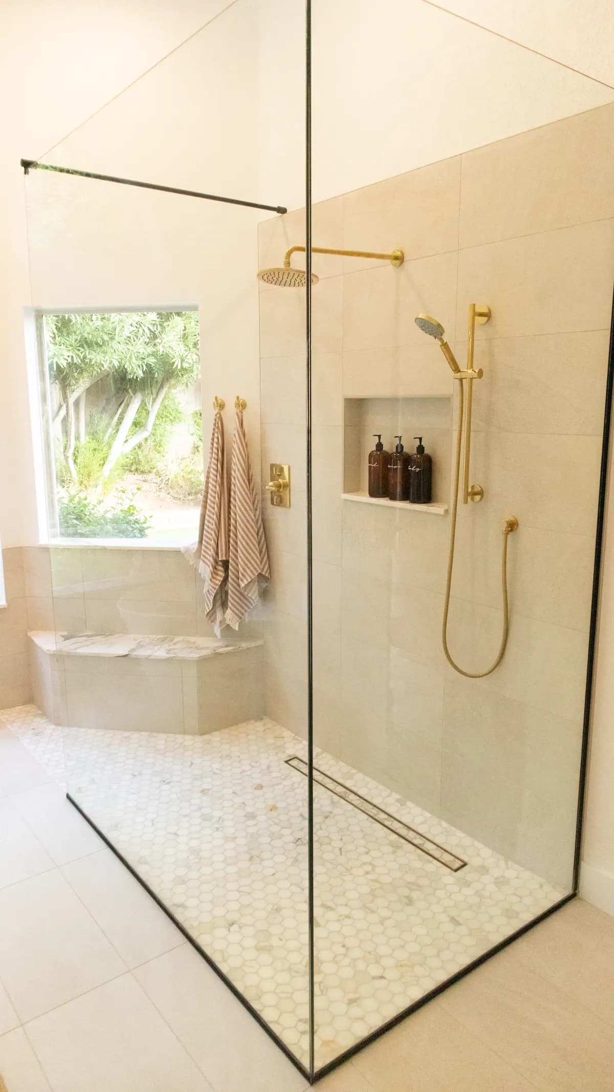Walk-in shower enclosed by clear glass panels