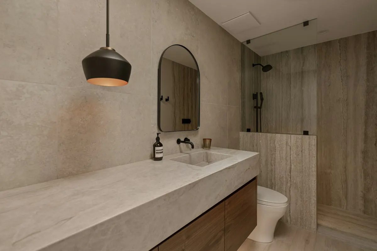 Bathroom vanity and adjoining tiled shower area
