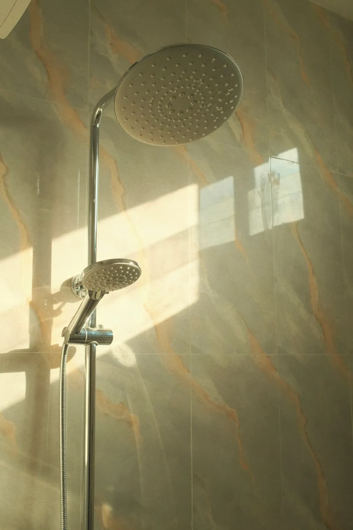 Sunlight across a shower screen and shower fittings